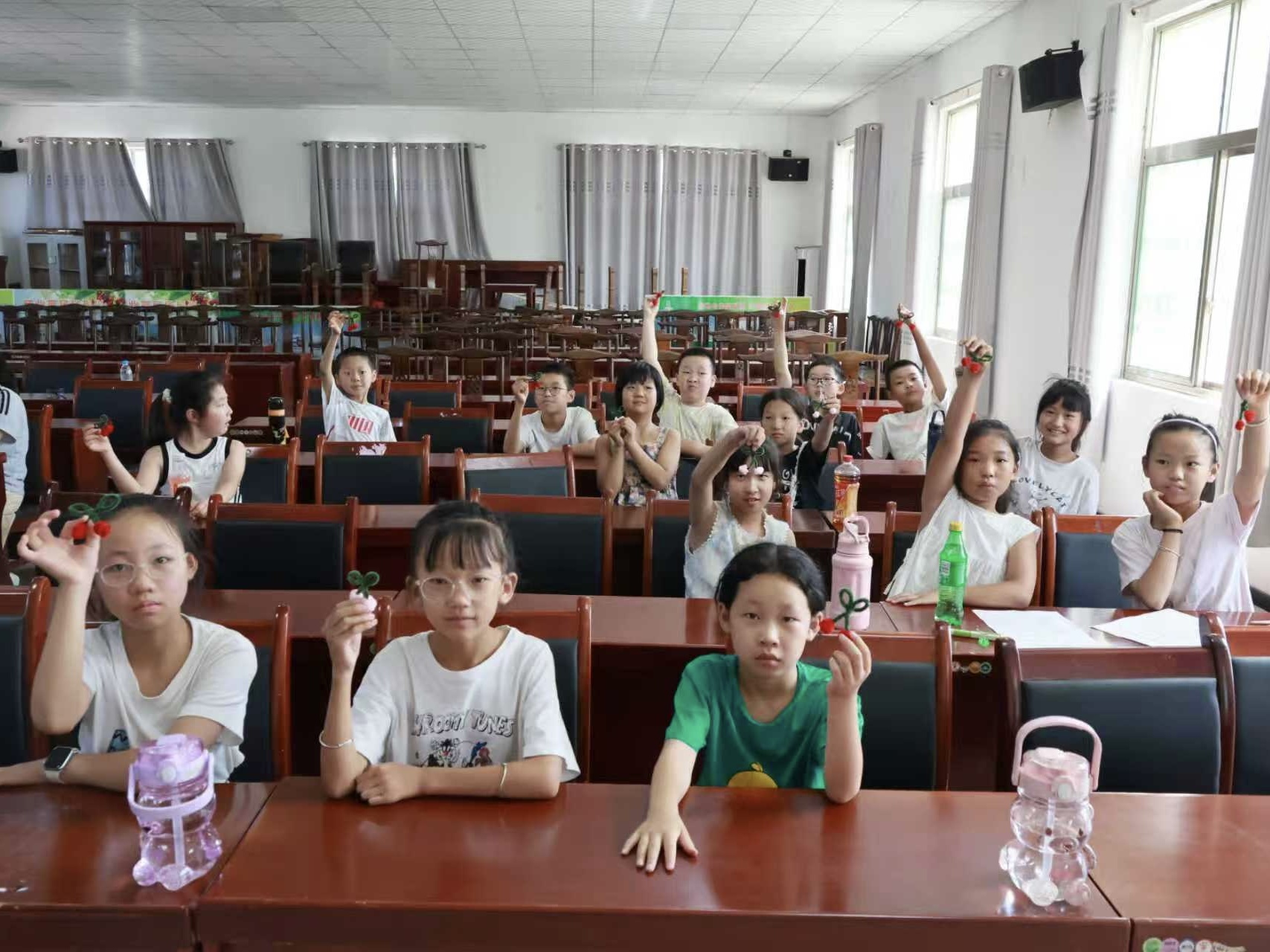 图2 孩子们展示樱桃扭扭棒作品（李通供图）.jpg
